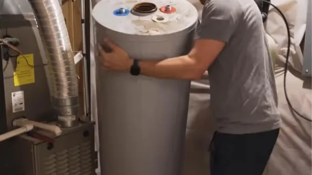 A worker carrying a storage water heater tank in a utility area